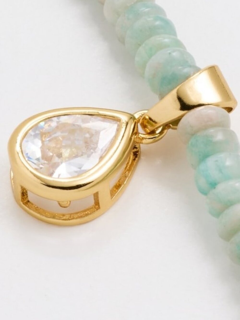 Gold-tone pendant with crystal inset